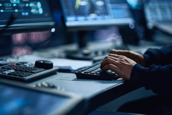 Close Up of a Professional Office Specialist Working on Desktop Computer in Modern Technological Monitoring Control Room with Digital Screens. Manager Typing on keyboard and Using Mouse.
